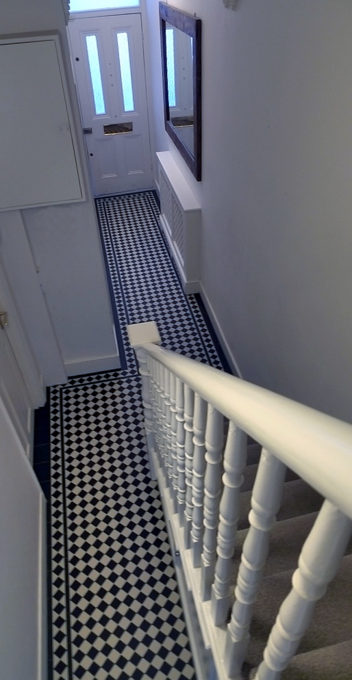 black and white victorian mosaic hallway tile path