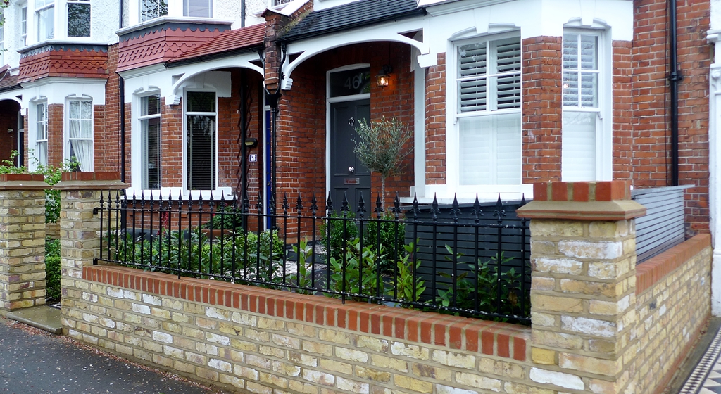 yellow brick front garden wall with rail wimbledon london