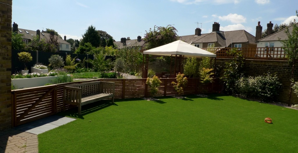large modern garden design earlsfield south west london artificial grass hardwood screens balau decking slate paving patio mature planting (27)