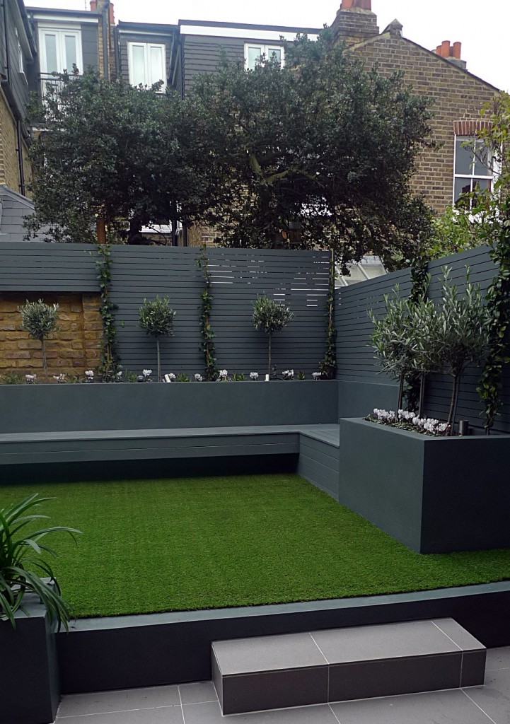 Raised beds grey colour scheme agapanthus olives artificial grass porcelain grey tiles yellow stock brick walls grey Floating bench Balham Clapham Wandsworth