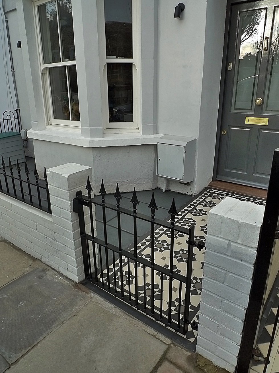 Iron bespoke metal gate rail render garden white walls painting London