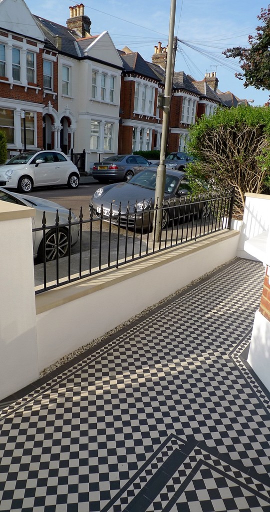 black and white victorian mosaic yorkstone render block wall wrought metal rail and gate docklands tower bridge london